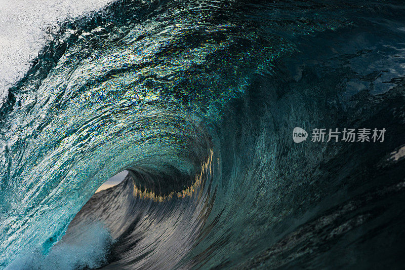 Close up detail of powerful teal blue wave breaking in the ocean